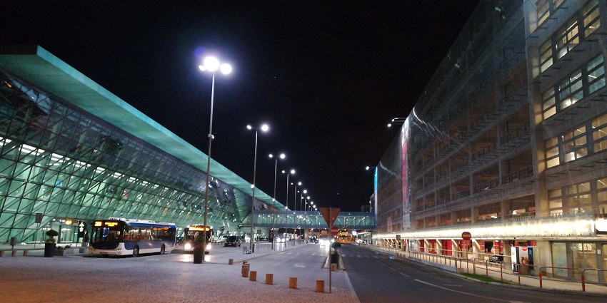 Kraków John Paul II International Airport with glass architecture and multiple buses