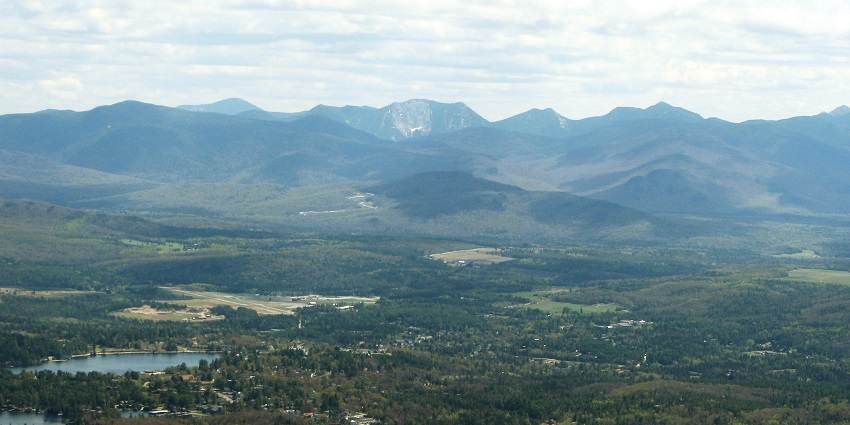 A stunning view of beautiful Lake Placid from McKenzie Mountain, Gothics in the back centre.