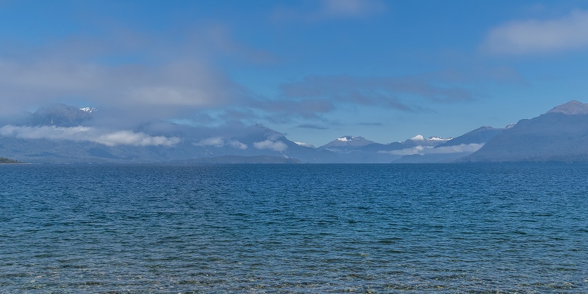 Witness Lake Te Anau, reflecting the Fiordland National Park’s surrounding mountains.