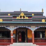 An image of Lava Monastery nestled in the Himalayan foothills, showcasing its architecture