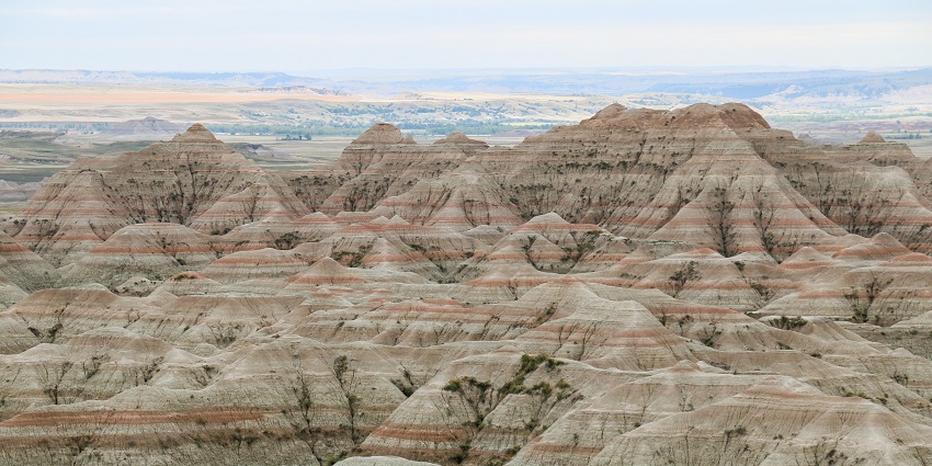 An image of the breathtaking valley nestled between towering mountains in the Badlands National Park.