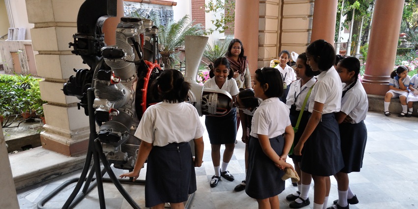 A picture of visitors at the Aircraft Museum Kolkata looking at a Continental Aero Engine.