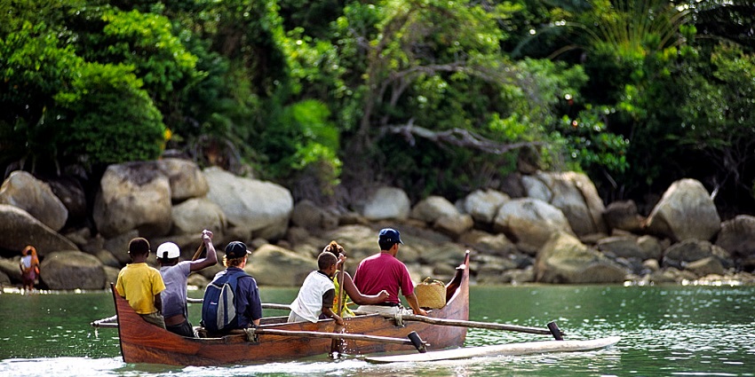 Image of local people and tourist boating in Lokobe Reserve - a place to visit in Madagascar