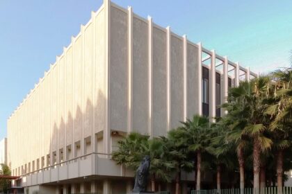 Exterior view of the Los Angeles County Museum of Art, with palm trees and modern sculptures