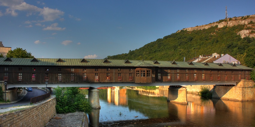 Bridge of love over the Osam River with covered architecture and mountains in Lovech