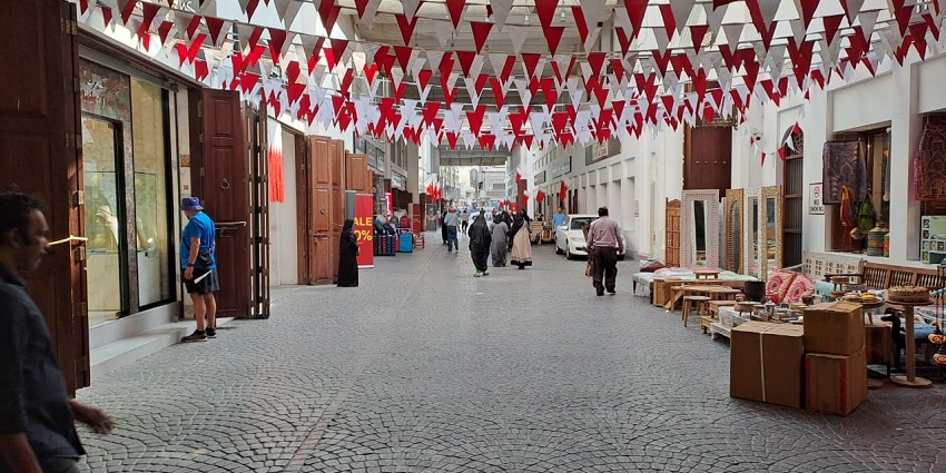 lively market selling spices, textiles, and traditional Bahraini items.