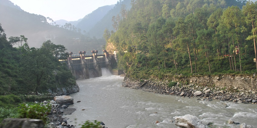 Maneri Dam on the Bhagirathi River near Uttarkashi Temple, amidst scenic mountain views.