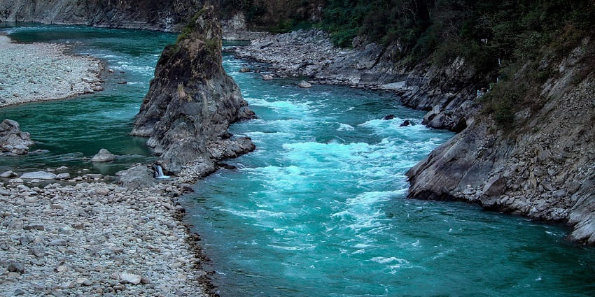 Surrounded by greenery, visit Manikarnika Kund.