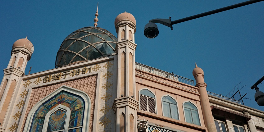 A building with Islamic architectural elements, including domes and arched windows