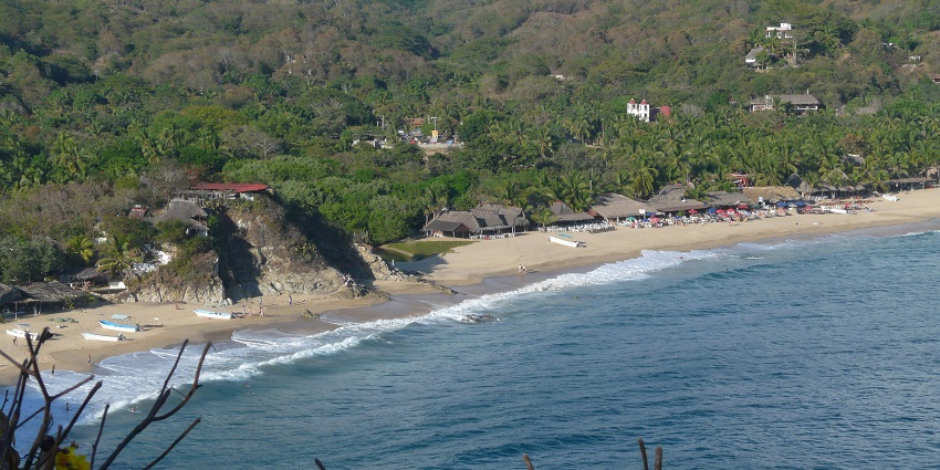 Mazunte Beach with calm blue waves, one of the beaches in Mexico’s Pacific Coast.