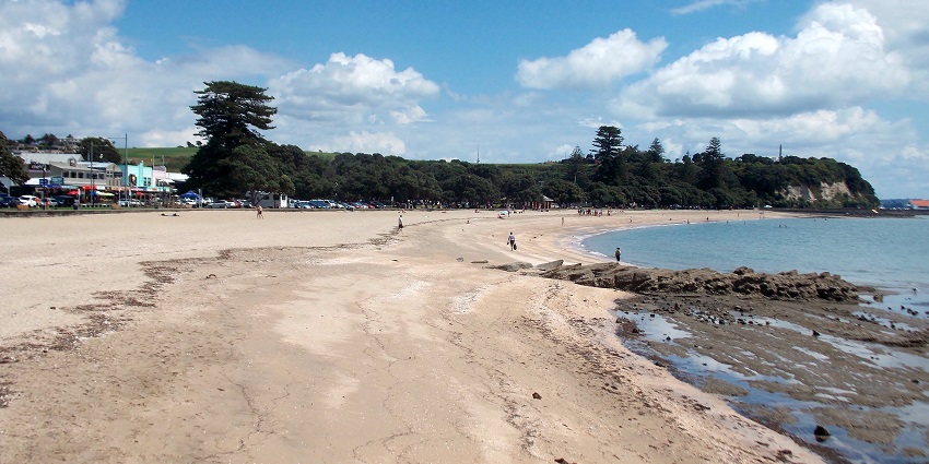A Family-friendly beach with cafes and a scenic view, one of the top Auckland beaches.