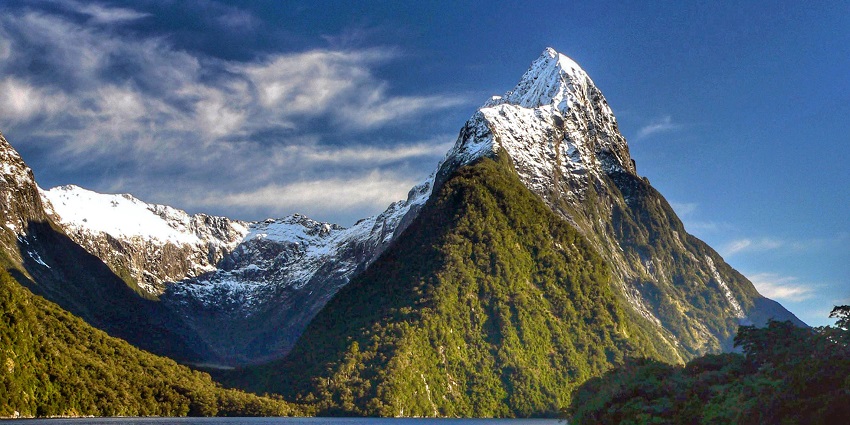 Mitre Peak stands majestically, framing Milford Sound Waterfalls’ iconic scenery