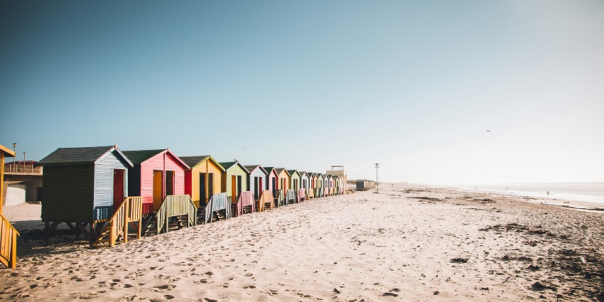A glimpse of enchanting landscapes and beach huts at Muizenberg Beach in South Africa.