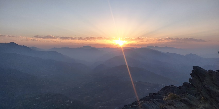 A scenic view of sunset in Mukteshwar's mountains, a unique place to visit near Bareilly.