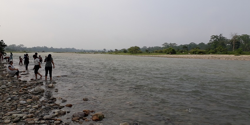 People enjoying the water in the Murti River near the Gorumara National Park.