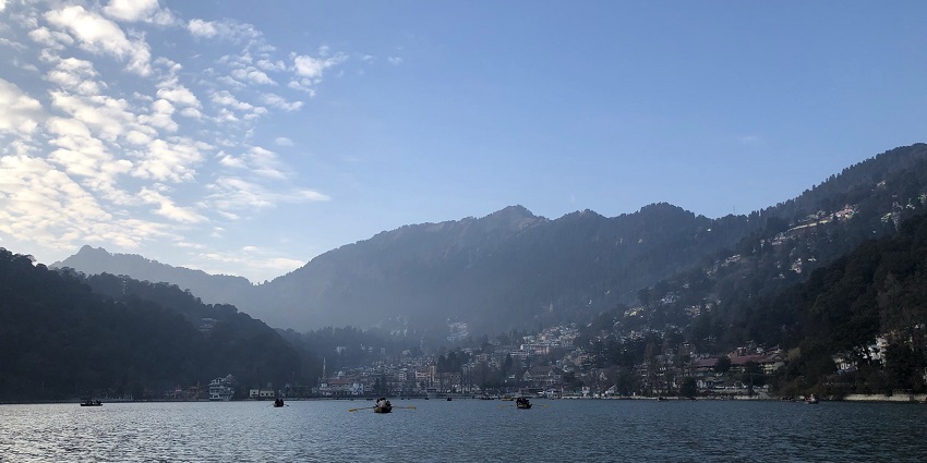 An image view of Naini Lake which is surrounded by lush green hills in Nainital.