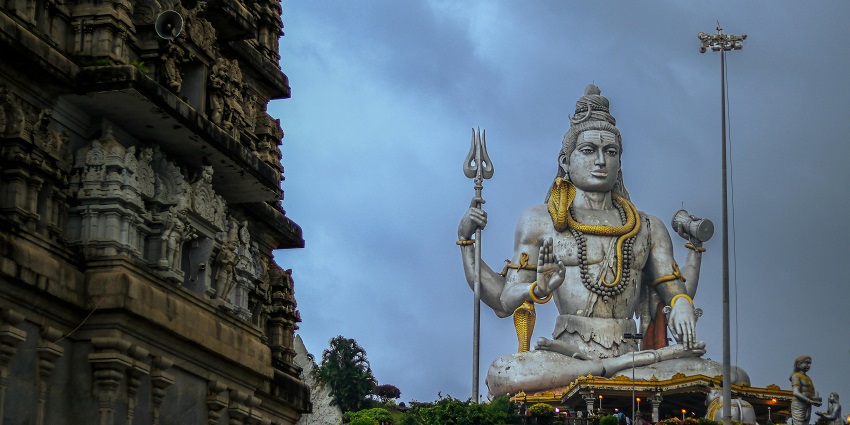 An image represents the Statue of Lord Shiva, a Hindu deity, holding a trident and sword.