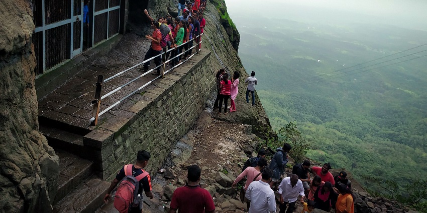 An image of Naneghat Caves, an intricacy of typical rock-cut carvings and inscriptions.