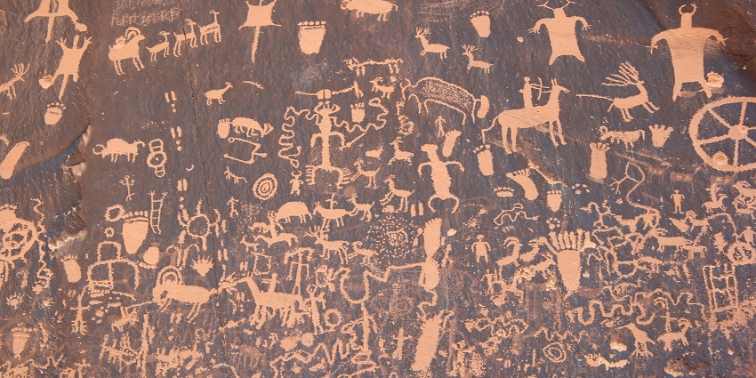 Ancient petroglyphs depicting animals and symbols on Newspaper Rock, a historical site