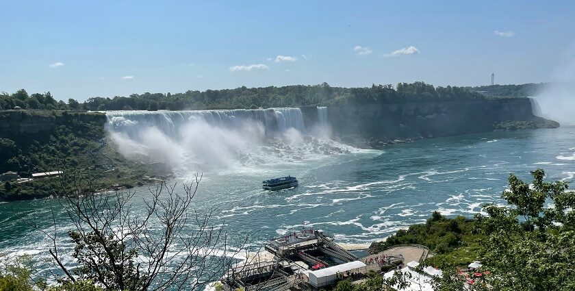 An image of Niagara Falls cascading powerfully with mist rising, viewed from the Ontario side, Canada