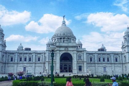 The vast white structure of Victoria Palace in Kolkata with a dome and large towers.