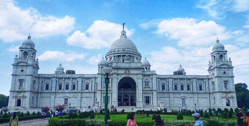 The vast white structure of Victoria Palace in Kolkata with a dome and large towers.