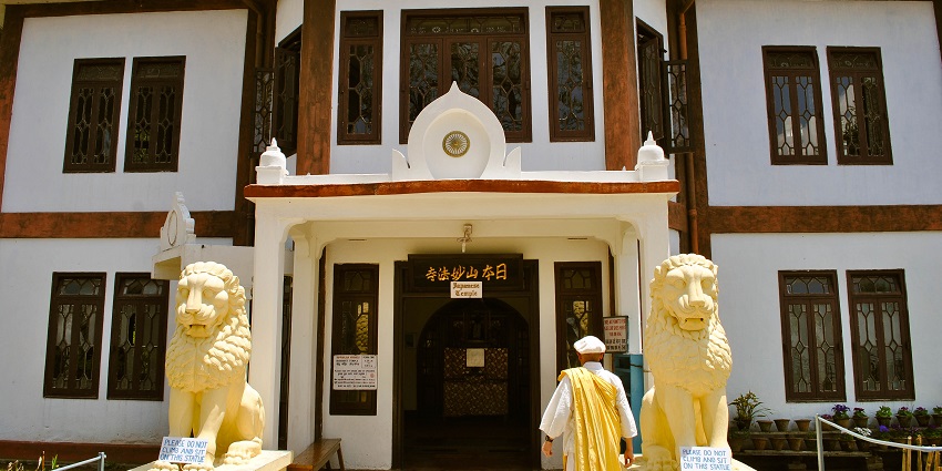 A picture of Nipponzan Myohoji Buddhist Monastery with traditional Japanese architecture.