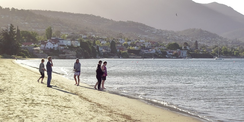 People fishing at the Nutgrove Beach, located in Sand Bay.