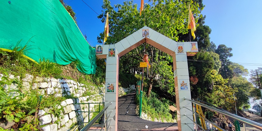 A picture of sacred Observatory Hill with prayer flags and a temple, a spiritual picnic spot.