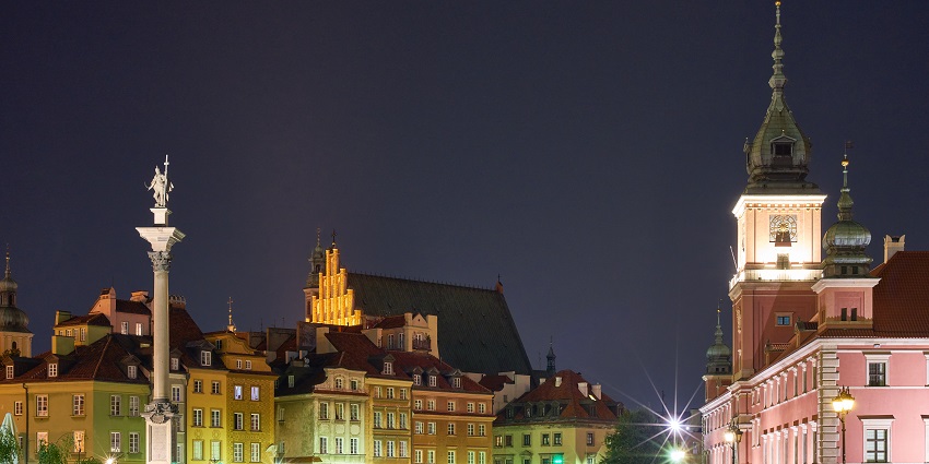 Warsaw old town at night with colourful lighting on the buildings and street lamps