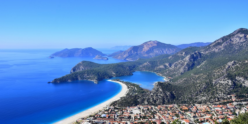 Scenic beach and lagoon, perfect for water sports and paragliding in Turkey.