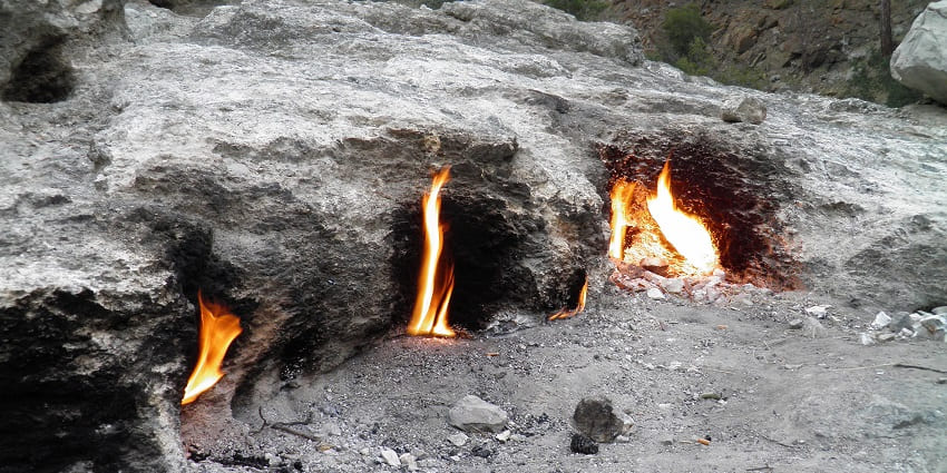 Ancient ruins and the natural phenomenon of eternal flames on the mountain.