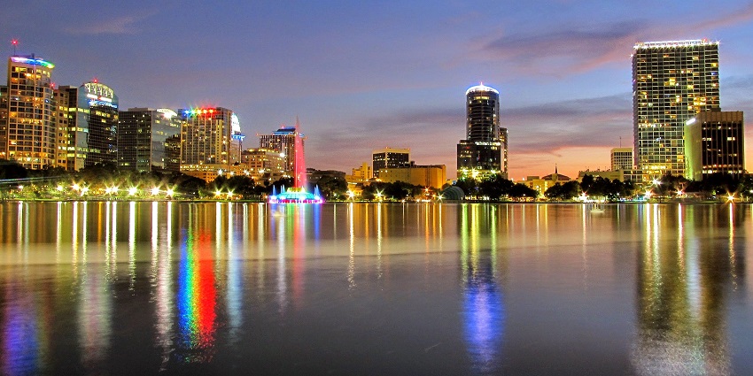 Picture of Lake Eola Park with the reflection of the beautiful city at night in Orlando.