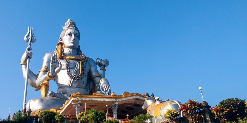 A picture of a tall statue of Lord Shiva near the Bagnath Temple