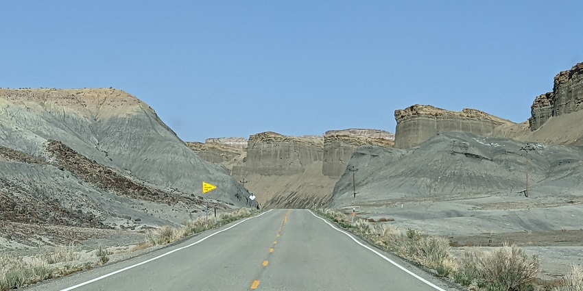 Image of a scenic view of US Route 24 winding through the National Park's red rock landscape.