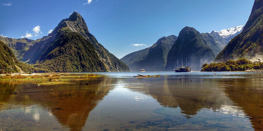 Journey to Milford Sound Waterfall to witness waterfalls weaves through cliffs
