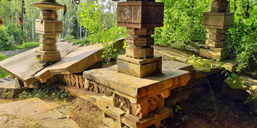 Image of an ancient metro pillars and broken rocks - surrounded by green forest