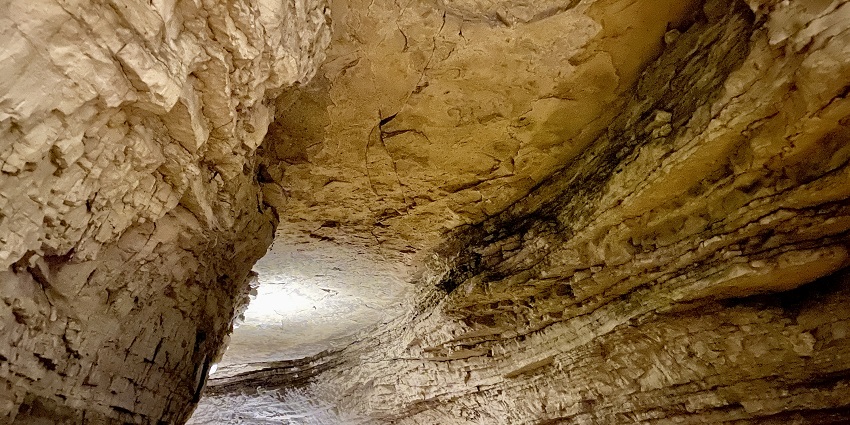 Dark, winding passage inside Mammoth Cave, part of Mammoth Cave National Park in Kentucky.