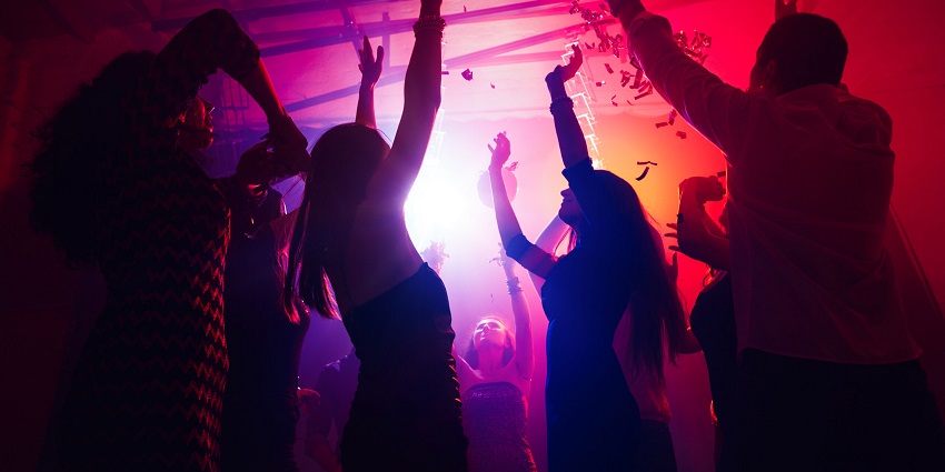 Lively nightclub with vibrant music, dance floor, and events.