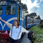 Preeti Singh of Taste of Siliguri posing in front of the iconic toy train or Joy Ride in Darjeeling.