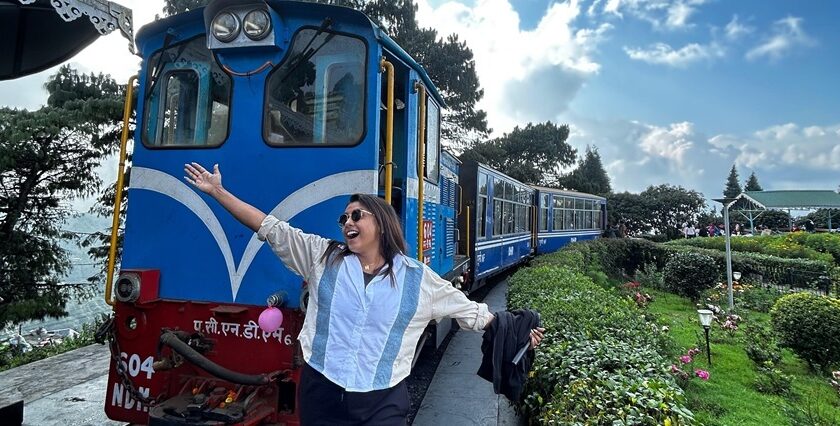 Preeti Singh of Taste of Siliguri posing in front of the iconic toy train or Joy Ride in Darjeeling.