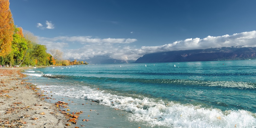 Peaceful lake offering stunning views of surrounding mountains.