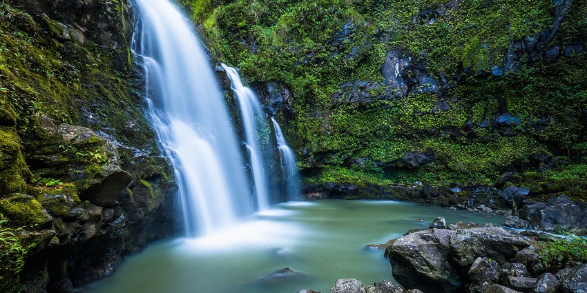 A picture of Paglajhora waterfalls in Kurseong, cascading down rocky terrain amid lush greenery