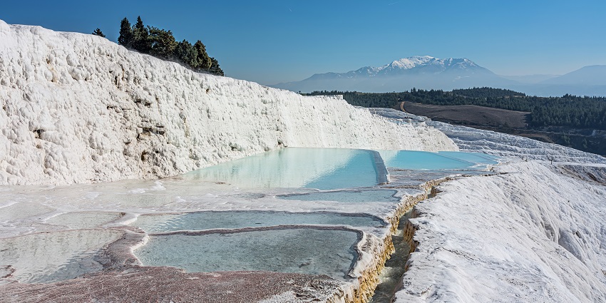 Thermal mineral springs create stunning white limestone terraces and pools.