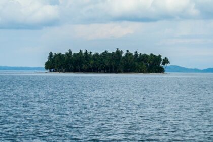 An image of an Island in Panama with clear blue water, sandy beaches, and rich green vegetation.