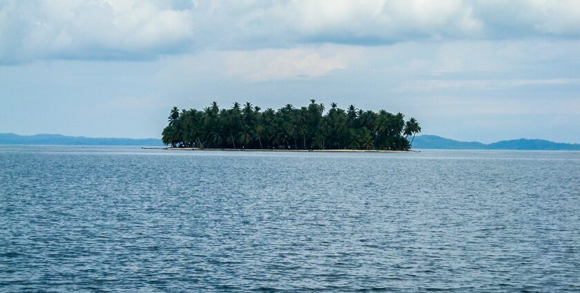 An image of an Island in Panama with clear blue water, sandy beaches, and rich green vegetation.