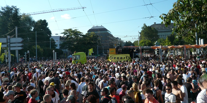 Image of annual techno parade with lively music and dancing crowd duringd ay time