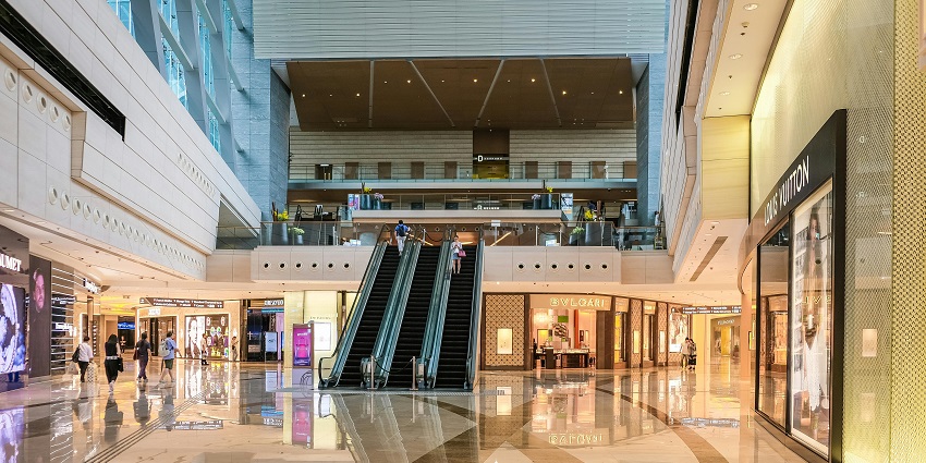 An image of the interior view of a shopping mall with multiple floors and retail shops.