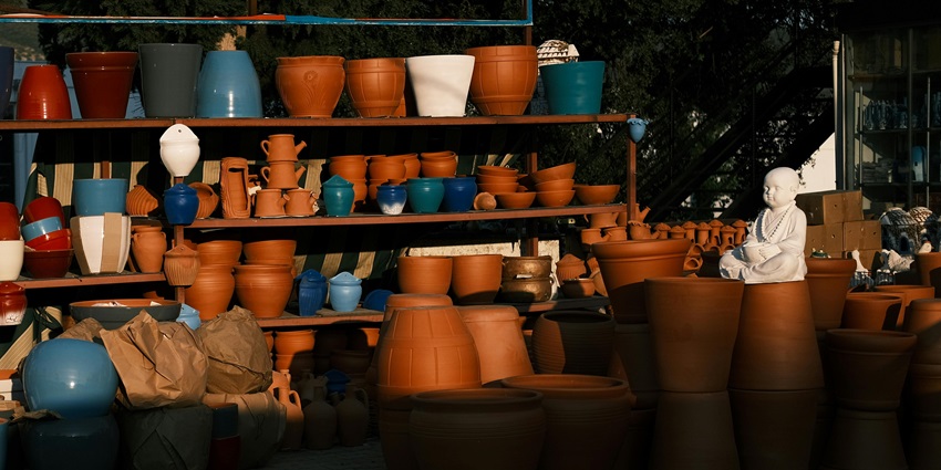 A collection of handcrafted clay pots arranged on display, showcasing traditional pottery styles in the local markets.