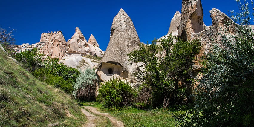 Scenic valley with ancient pigeon houses carved into rocky cliffs